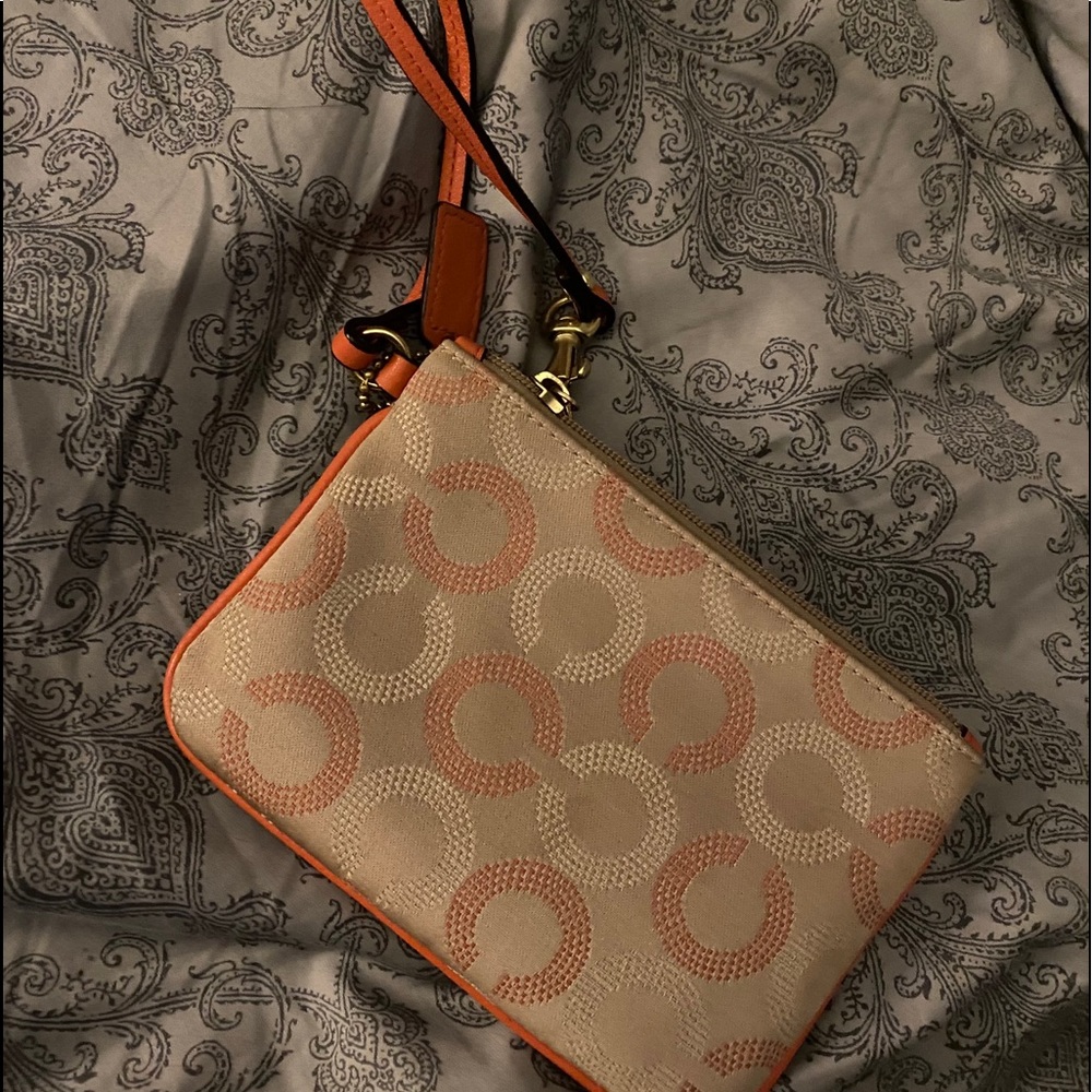 COACH wristlet, coral color. Great condition.